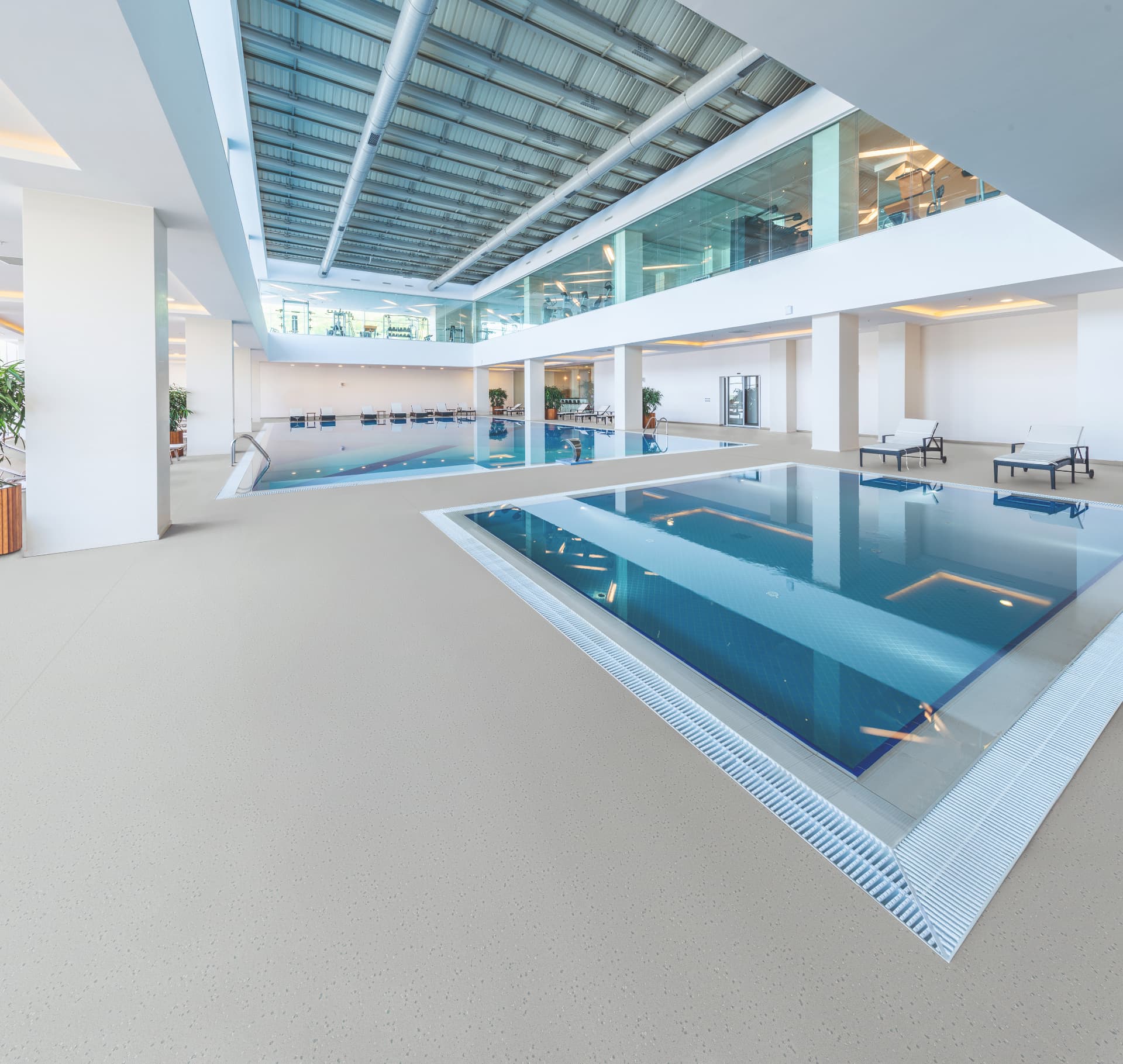 Indoor aquatic centre with seamless slip-resistant poolside flooring