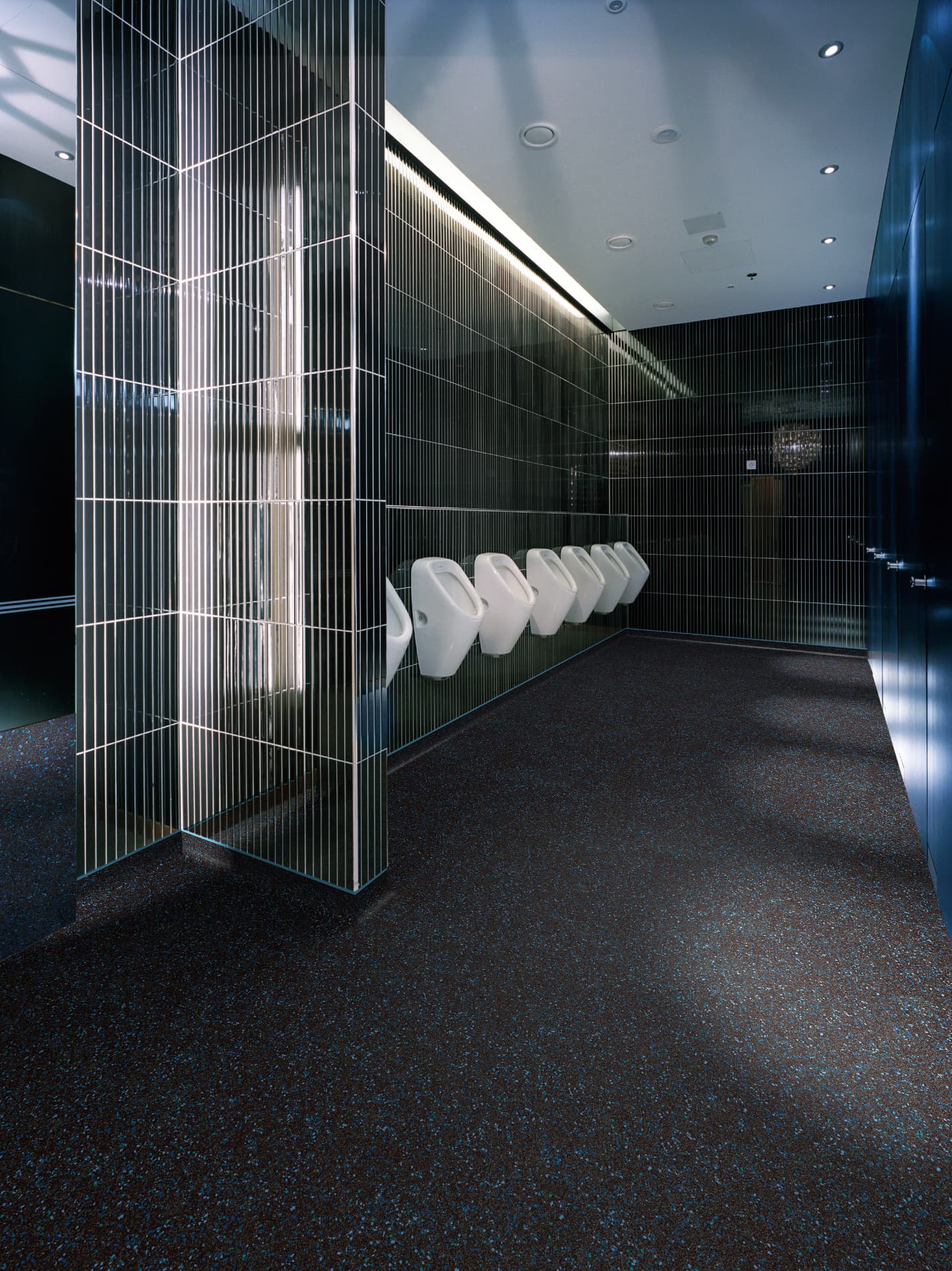 Commercial washroom with speckled safety vinyl flooring