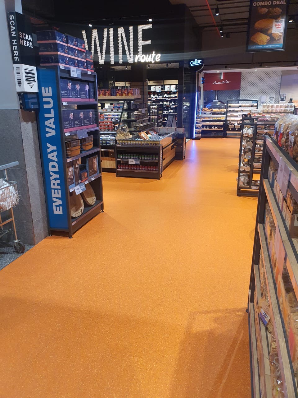 Supermarket wine route with seamless orange quartz flooring