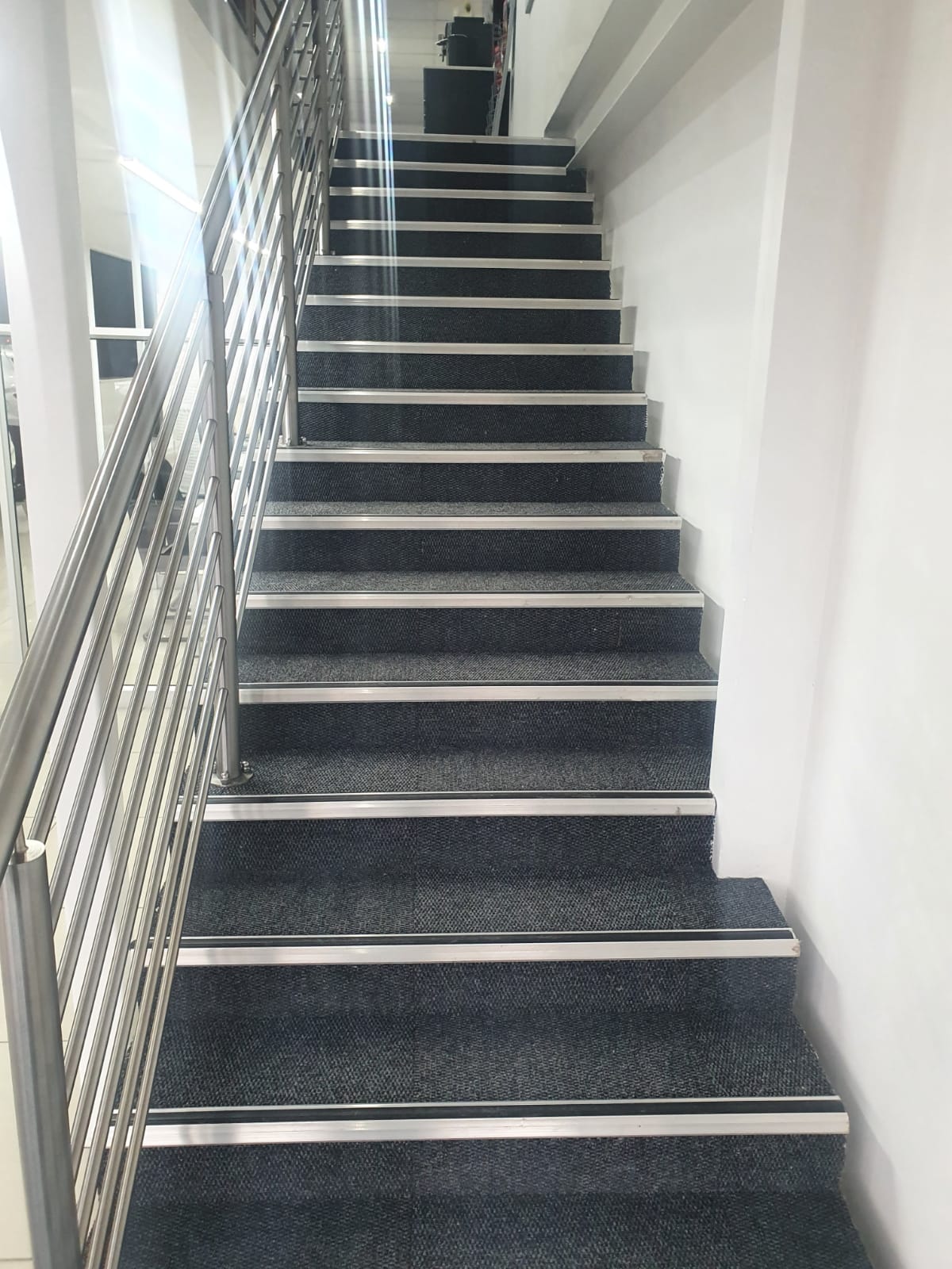 Carpeted staircase with metal nosings