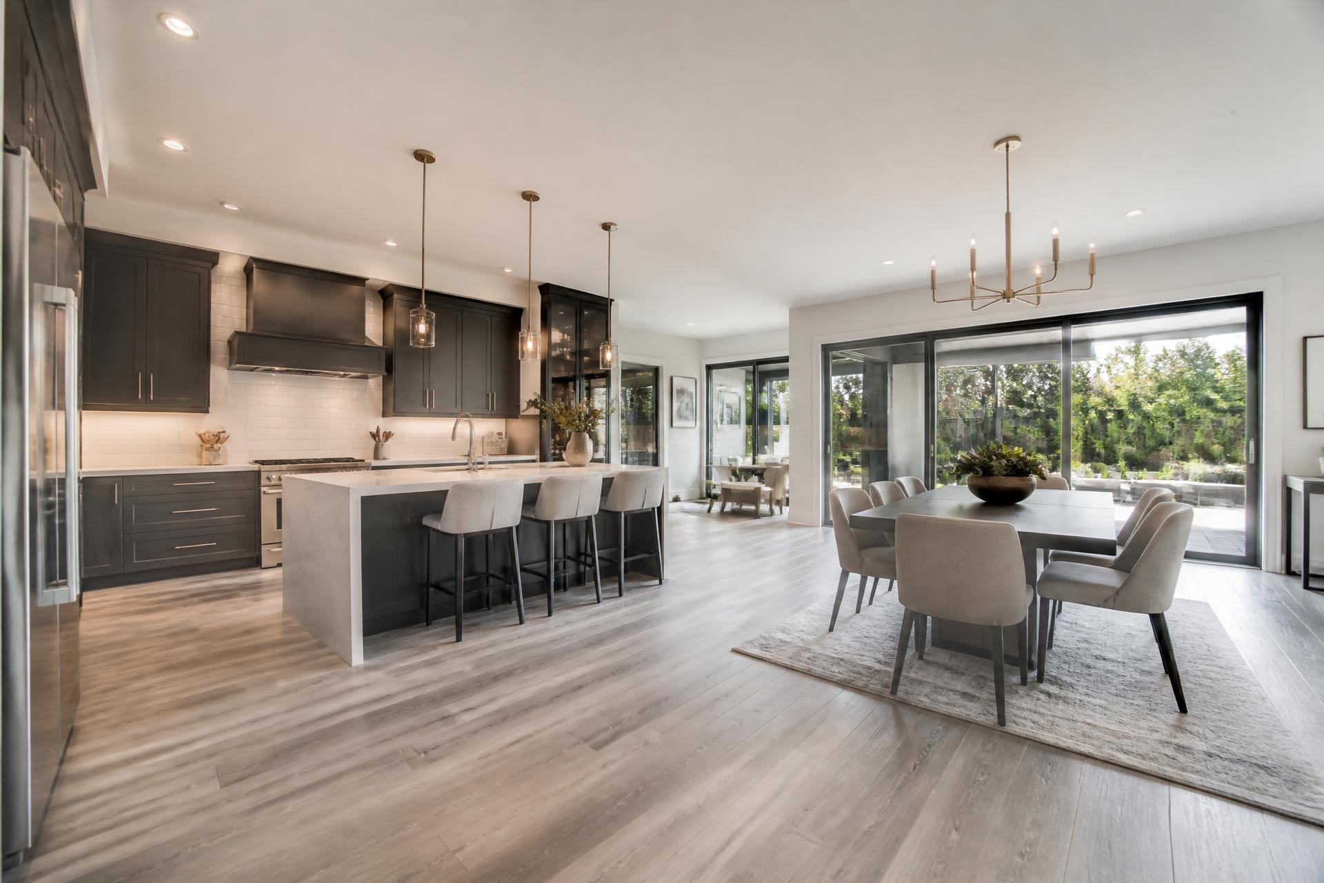 Modern open-plan kitchen with light grey vinyl plank flooring